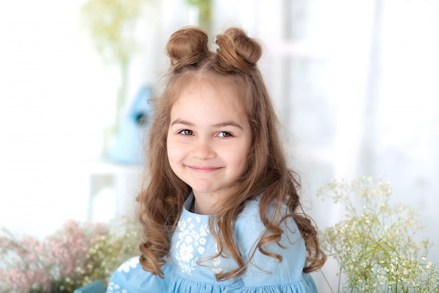 portrait of face of little beautiful girl with long hair. Closeup portrait of a little smiling girl. March 8, International Women's Day, Mother's Day. Portrait of a happy smiling child girl. Childhood