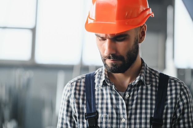 portrait of factory worker in protective equipment in production hall