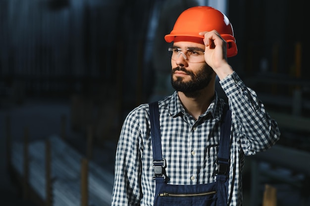 portrait of factory worker in protective equipment in production hall