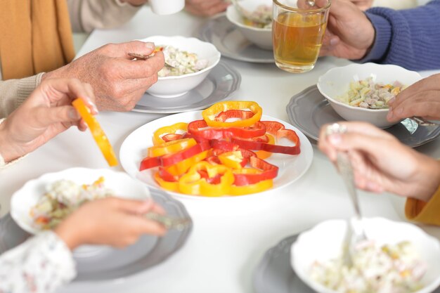 Portrait of a family eating salad close up