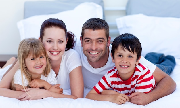 Portrait of family lying in bed together