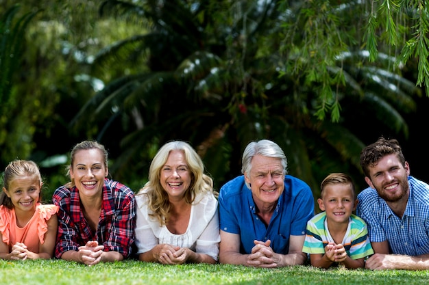 Portrait of family lying on grass at yard