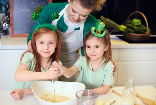 Portrait of family mixing dough