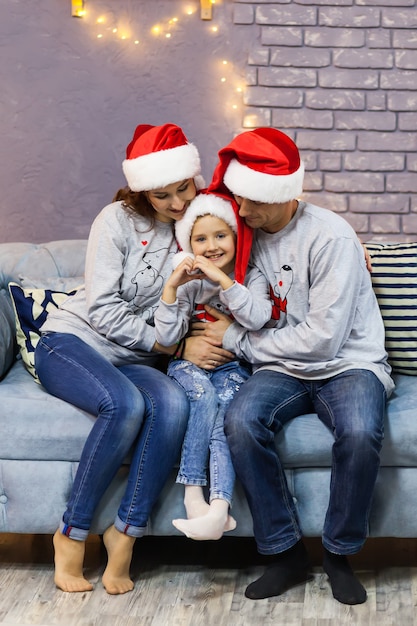 Portrait of family in red Santa caps