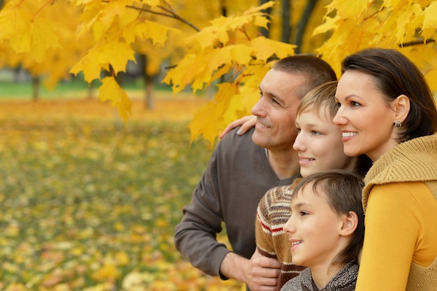 Portrait of family relaxing in autumn park