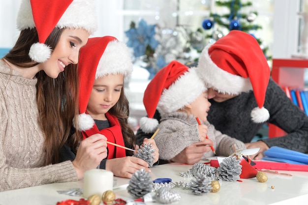 Portrait of family in Santa hats preparing for Christmas