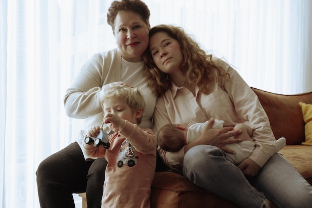 Photo portrait of family with grandmother and daughter holding a newborn son