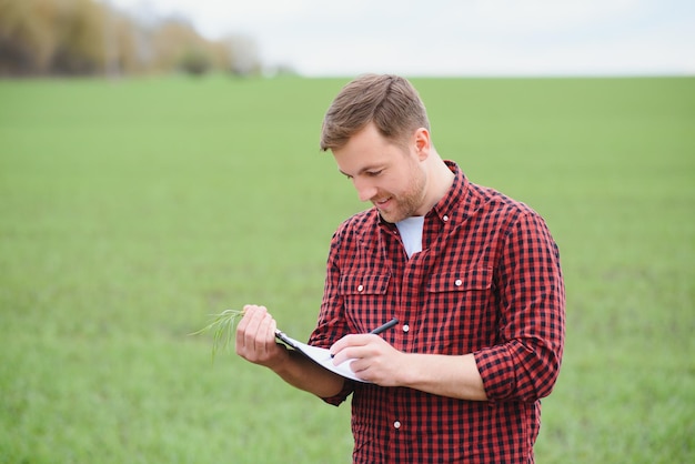 Portrait of farmer standing in wheat field