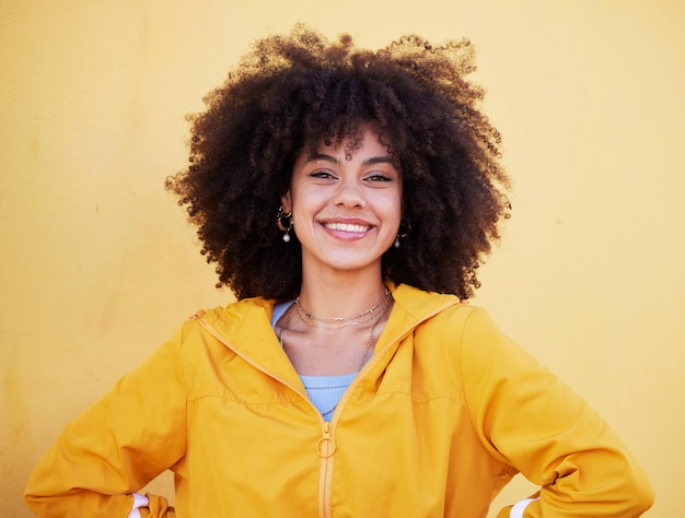 Photo portrait fashion and happy with an afro black woman in studio on a yellow background for style trendy hair and smile with an attractive young female posing alone on product placement space