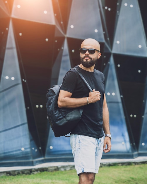 Portrait of a fashion young man at beautiful dark urban background