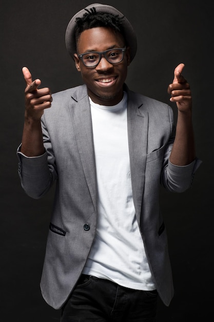 Portrait of a fashionable african american man smiling on black background