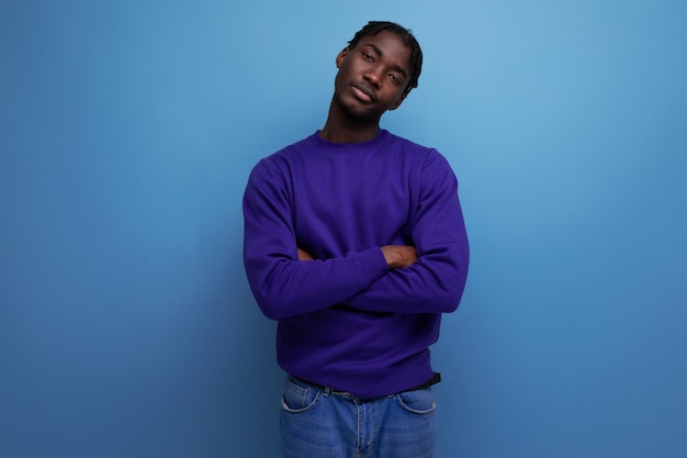 Portrait of a fashionable darkskinned american young guy in casual clothes in the studio