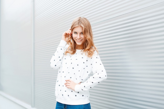 Portrait of fashionable fun woman with a beautiful smile on a light background