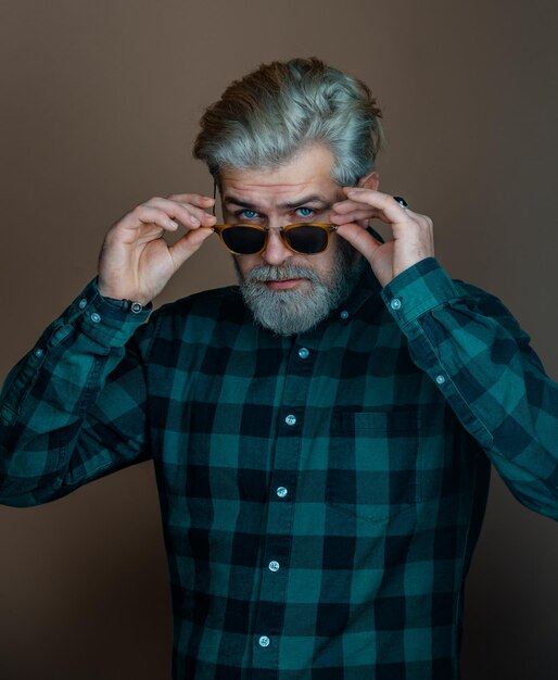 Portrait of fashionable handsome man in look at camera Man with fashion sunglasses Handsome man studio portrait