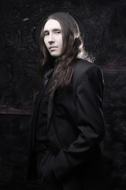 portrait of a fashionable male model with long hair 