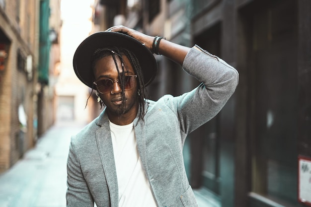portrait of fashionable young man standing on street in city