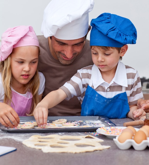 Portrait of father and children baking