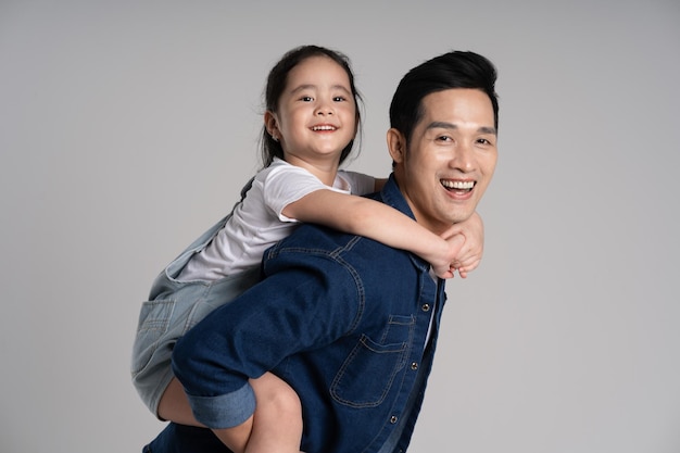 portrait of father and daughter posing on white background