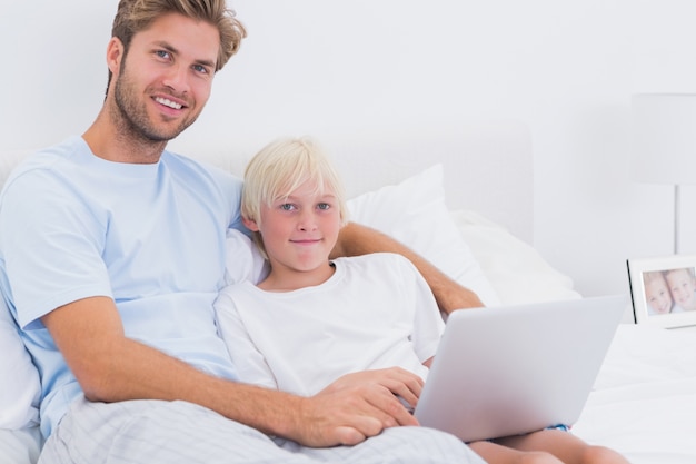 Portrait of a father and his son using a laptop