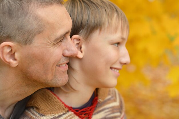 Portrait of father and son in autumn park