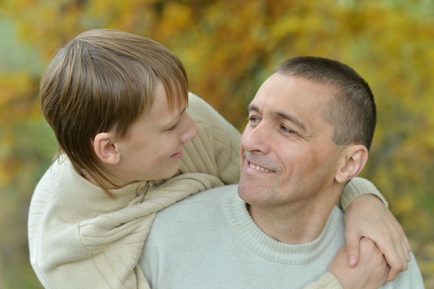 Portrait of father and son in autumn park