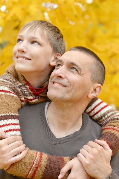 Portrait of father and son in autumn park