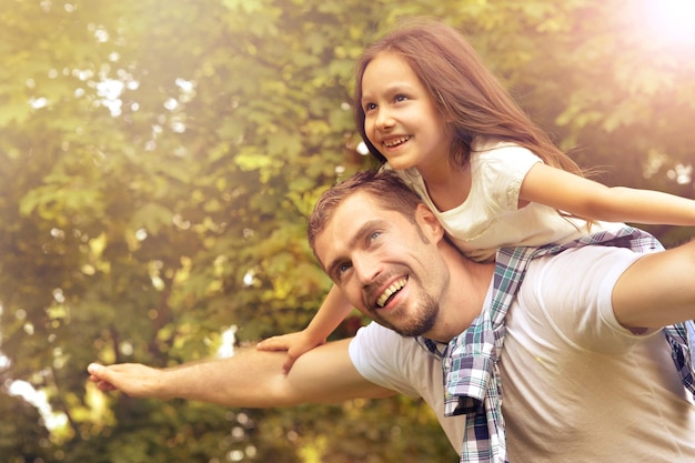 Portrait of father with daughter in summer park