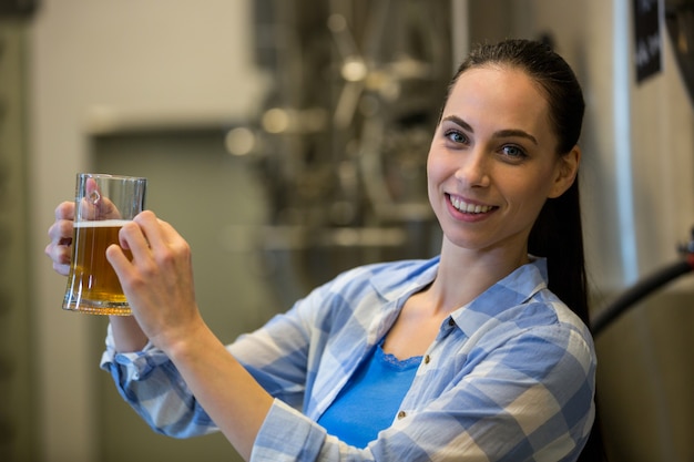 Portrait of female brewer testing beer