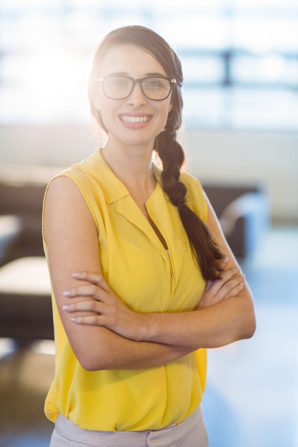 Portrait of female business executive standing with arms crossed