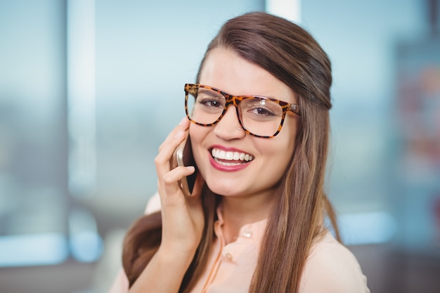 Portrait of female business executive talking on mobile phone