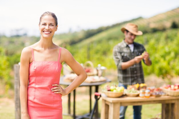 Portrait of female customer standing in front of stall