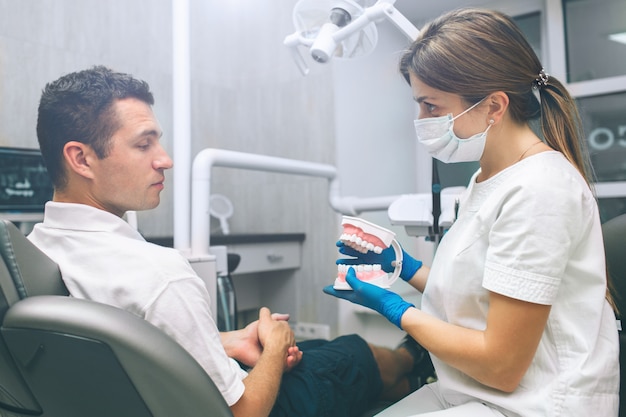 Portrait of a female dentist and young happy male patient in a dentist office. man