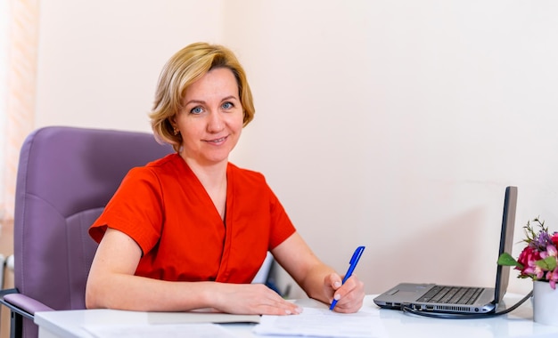 Portrait of a female doctor in hospital Woman looking at camera and smiling Modern office background