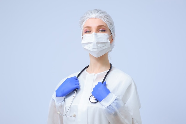 Portrait of a female doctor or nurse wearing medical cap and face mask