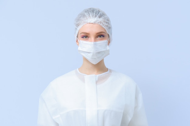 Portrait of a female doctor or nurse wearing medical cap and face mask