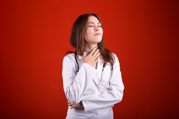 Portrait of a female doctor on a red background