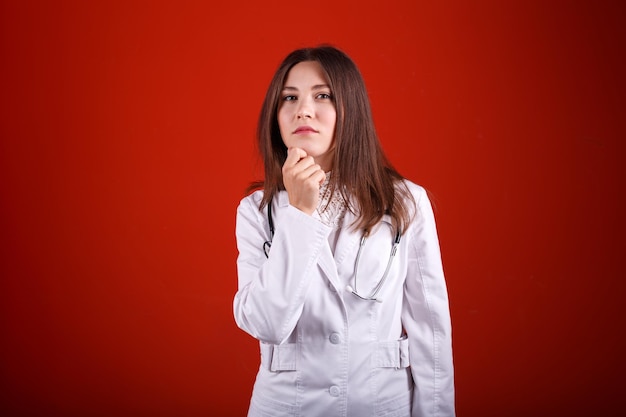 Portrait of a female doctor on a red background