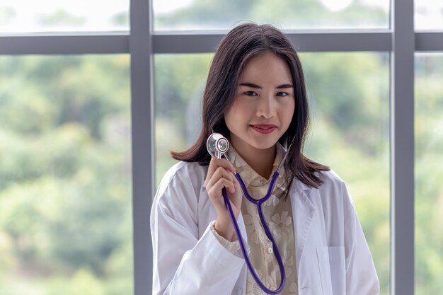 Portrait of a female doctor showing a stethoscope