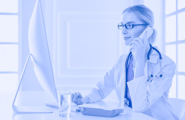 Portrait of female doctor using his mobile phone in the office