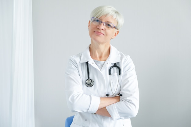 Portrait of female doctor on white background. 