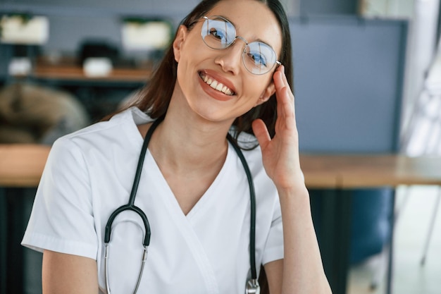 Portrait of female doctor in white coat is that is indoors