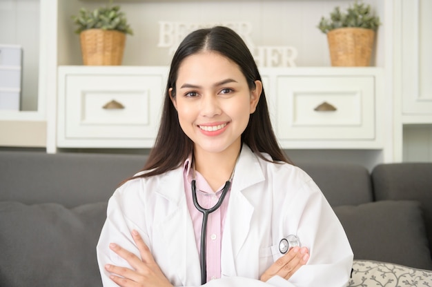 Portrait of Female doctor with stethoscope at office and smiling at camera.