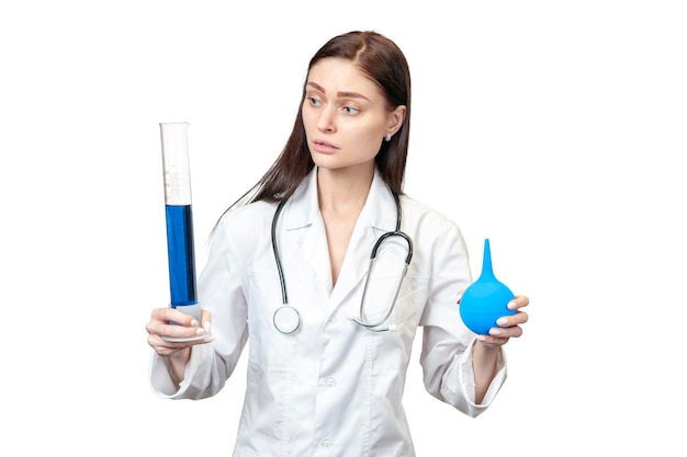 Photo portrait of a female doctor with a test tube and enema in hands isolated on white background