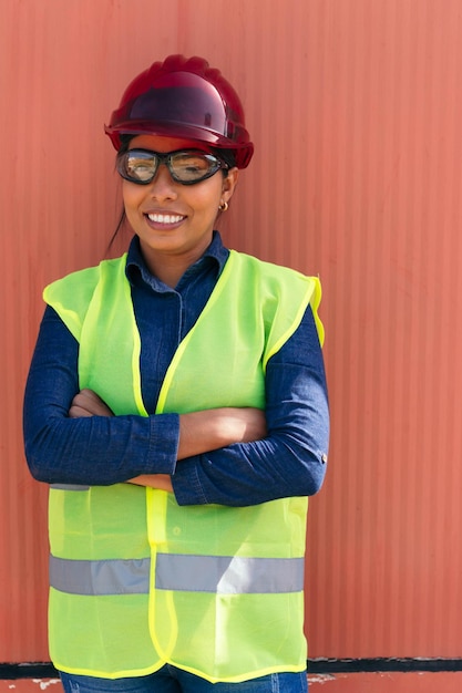 Portrait of a female Hispanic worker in a hard hat factory