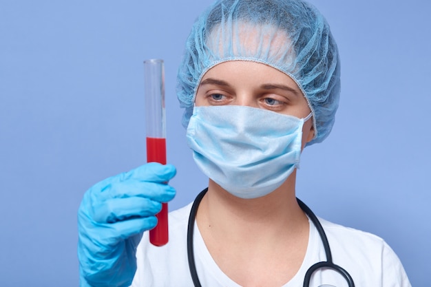 Portrait of female holding blood tube test