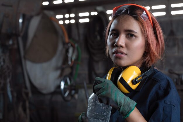 Portrait of female mechanic at garage