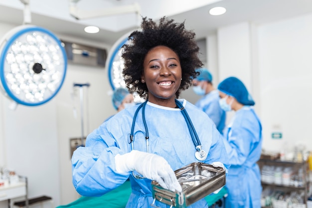 Portrait of female medical worker in protective mask preparing for surgery