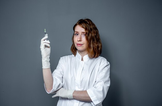 portrait of a female medical worker with a syringe in his hands