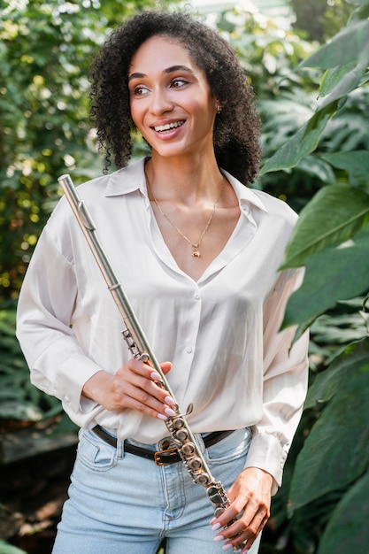 Portrait of female musician playing wind instrument for world music day