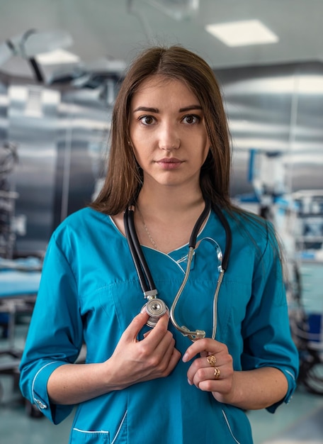 Portrait of female nurse in white uniform and stethoscope in operating room in hospital